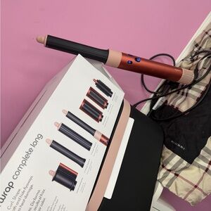 Dyson long barrel hair styler in copper and pink